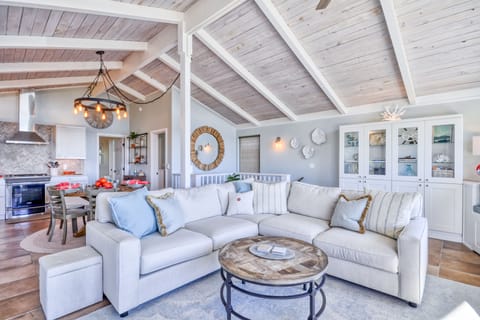 The living area with a large sectional, dining table that seats up to 8 people.