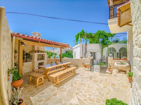 Exterior dining area with barbecue.