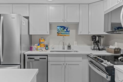 Cozy and modern open space featuring a fully equipped kitchen, inviting dining area, and bright living room—perfect for relaxing and enjoying your stay.