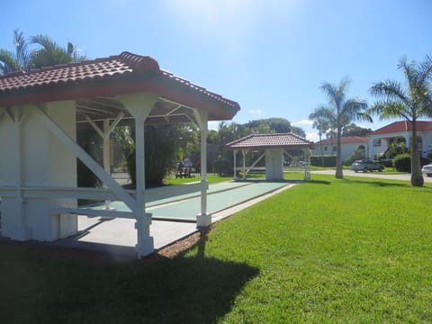 Shuffleboard deck adjacent to main pool and tennis courts.