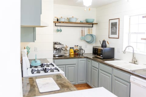 - Farmhouse inspired kitchen with curated cookware and smart open shelving - Fully equipped with essential appliances, gourmet essentials, and natural light - Perfect blend of form and function, ideal for preparing meals or a fresh brew