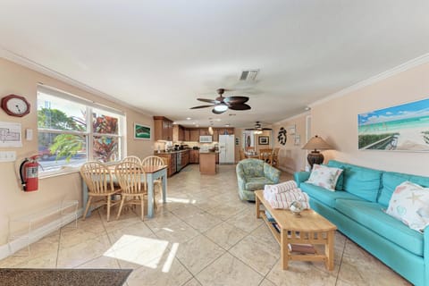 Relax in your bright, open living space where turquoise sofas and tropical touches create the perfect beach getaway atmosphere.