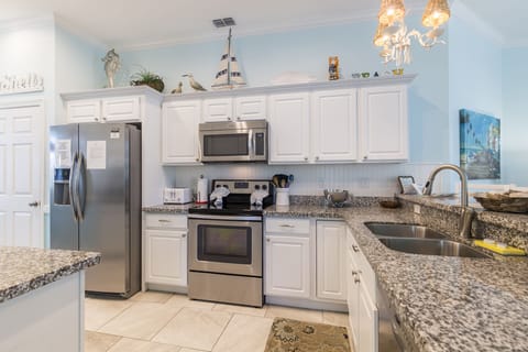 Kitchen is fully equipped and has stainless steel appliances.