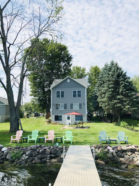 view of house from lake and dock