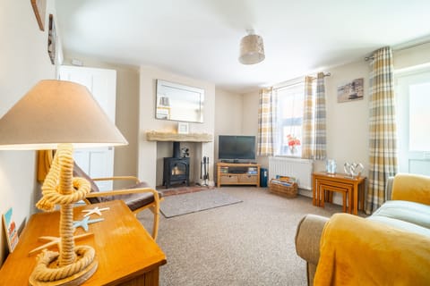 Seaside Cottage, Wells-next-the-Sea: Sitting room with a wood burning stove