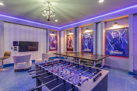 Amazing arcade room with game consoles, foosball, ping pong table, and air hockey