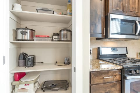 Fully stocked gourmet kitchen featuring cooking supplies