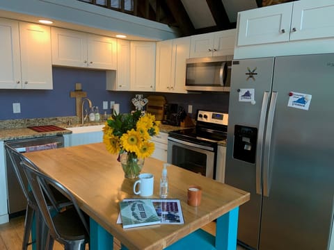 Updated kitchen with stainless steel appliances and island with seating