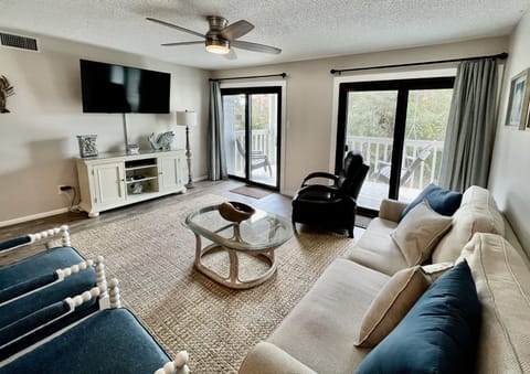 Balcony access in living room. Flat screen smart TV with cable & DVD player. 