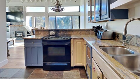 Kitchen with direct view to living and dining rooms.