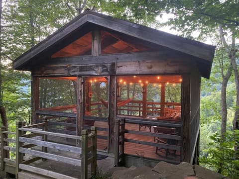 Treetop porch lit up at dusk