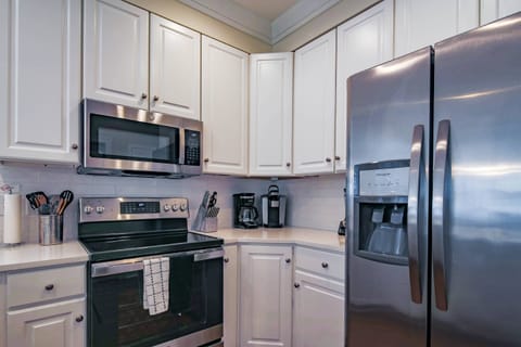The kitchen has a refrigerator, range, microwave, coffee maker, keurig & blender.