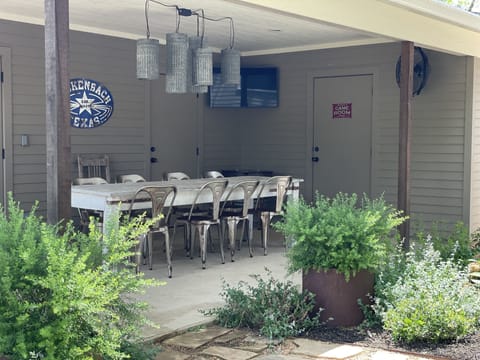 Covered back porch with a large table that seats 8. 