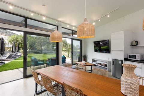 Secondary dining area next to the pool and gas BBQ.
