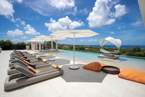 Private pool with sun-loungers and ocean view