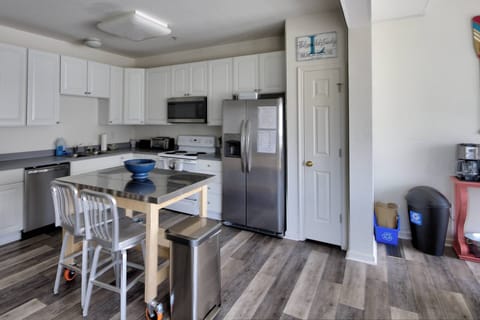 The kitchen is well stocked and has extra seating at the island.