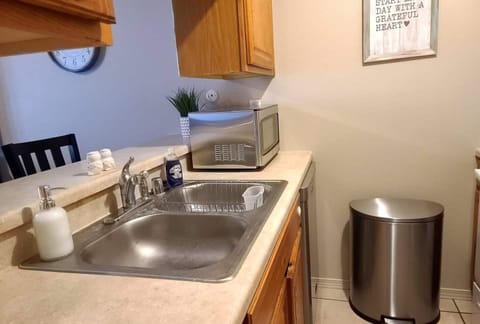 Kitchen with breakfast bar, dishwasher, microwave