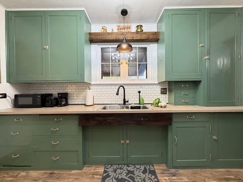 Newly painted cabinets and backsplash that leave the kitchen feeling open and cozy.