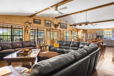 Spacious open-concept living, dining, and kitchen area with rustic decor and plenty of room to relax or entertain.