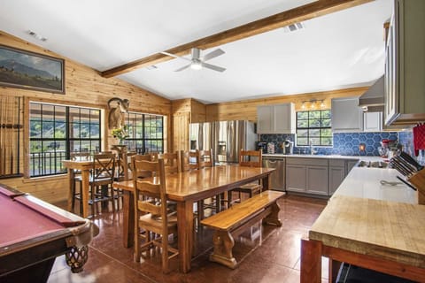 Spacious kitchen and dining area with rustic charm, modern appliances, and scenic views-perfect for family meals and gatherings.