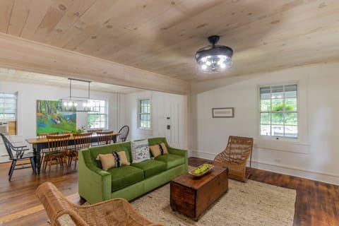 Living room: Green Sofa has queen air Mattress.