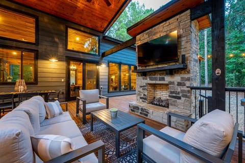Relax by the outdoor fireplace while enjoying the peaceful forest surroundings.