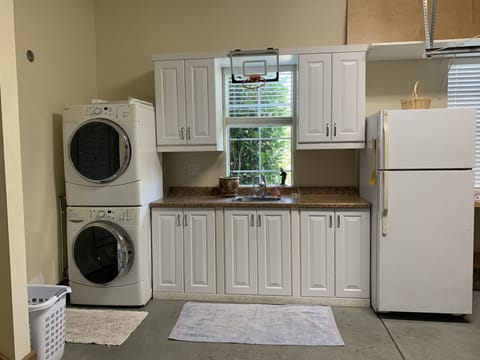 Washer, dryer and extra fridge in the garage. 