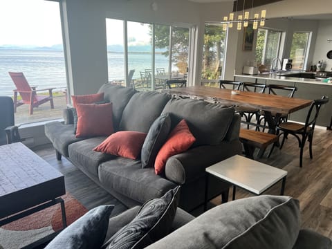 The living room connects with dining and kitchen, featuring all-new furnishings.