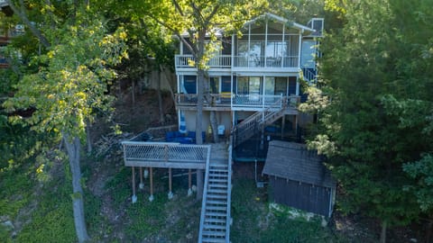 View of the back of the house, 3 level patio with solar lit staircase and dock