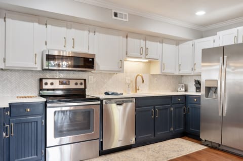 New stainless steel appliances and quartz countertops.