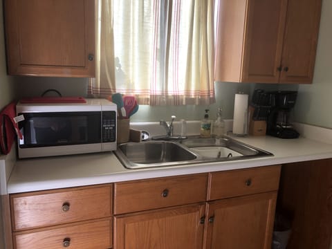 full kitchen sink with microwave and coffeemaker as well