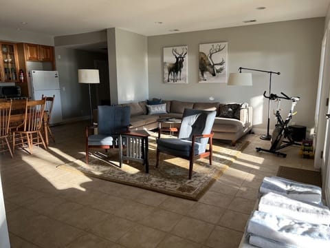 Lower level family room with spin bike and hand weights. Full kitchenette.