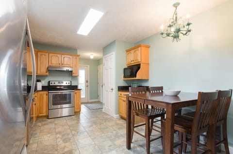 A full view of the kitchen with an eat-in table.