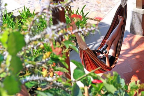Enjoy our hammocks + a cool drink in our next door garden cafe