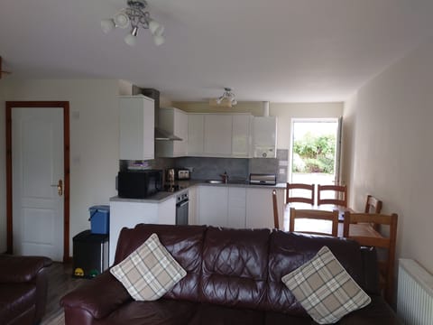 Kitchen with oven, dishwasher, washing machine, under counter fridge.