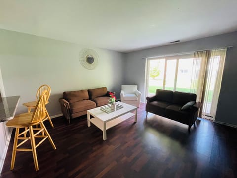The living room comes furnished with essential pieces, including a comfortable sofa, a coffee table, and a TV stand, providing immediate comfort upon move-in.