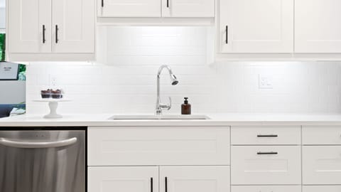 Kitchen: quartz countertops, dishwasher, stove, microwave, and refrigerator.