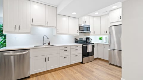 Kitchen: quartz countertops, dishwasher, stove, microwave, and refrigerator.