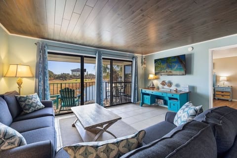 View of den with couch and loveseat and flat screen television