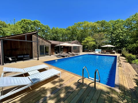 Pool deck with hot tub. EOS Chaise Loungers and covered seating area.