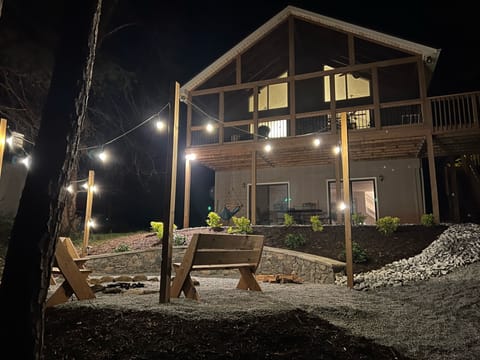 Well-lit firepit area with plenty of seating.