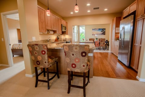 Gourmet kitchen with granite counters, bar seating, and premium appliances.