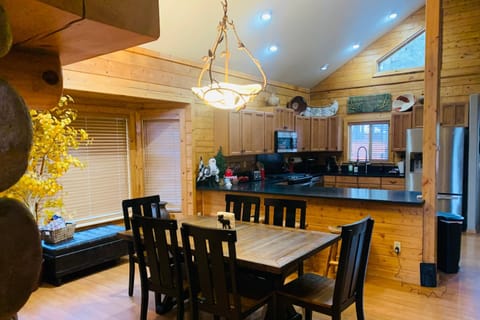 Open living dining and kitchen space make River Rock Cabin a great family-oriented home. Spread out in this 4 bedroom, 2 story 5 star home!