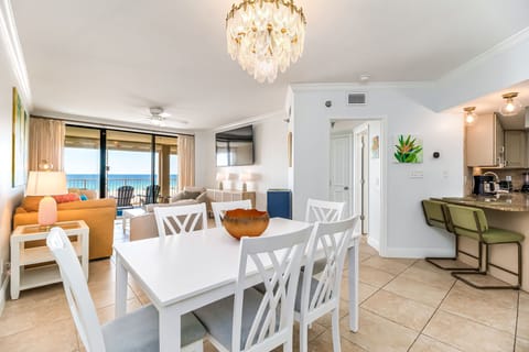 Open-concept living and dining with crystal chandelier at renovated Orange Beach vacation rental