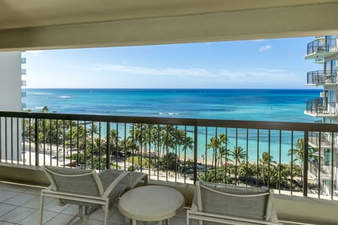 Breathtaking oceanfront views frame your private balcony, where you can watch waves roll in and surfers carve the turquoise water. Sip morning coffee or unwind at sunset while palm trees sway below—pure paradise at your fingertips.