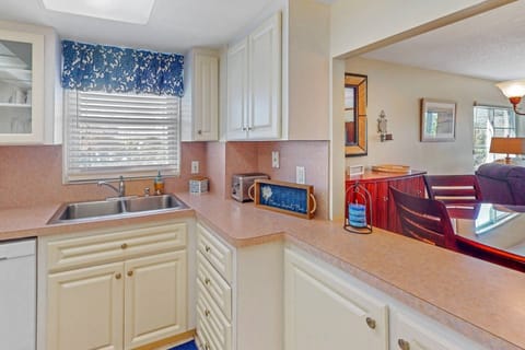Clean kitchen with all the necessary appliances and a pass thru to the indoor dining area.