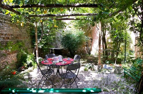 With a Wisteria-covered Arbor and  a Lemon Trees