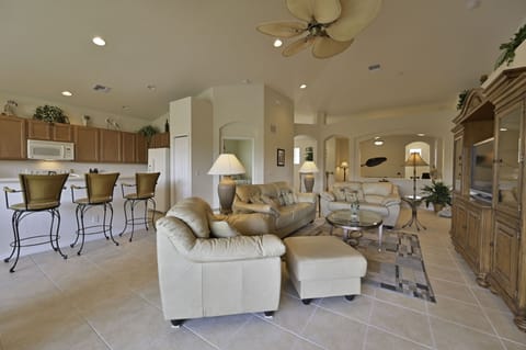 SWM3222 - Spacious living with high vaulted ceiling, flat screen TV and sliding doors opening up to the screened in balcony with beautiful lake view.