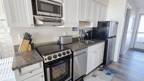 Galley kitchen with new stainless appliances