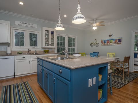 Kitchen island with sink and extra seating.
